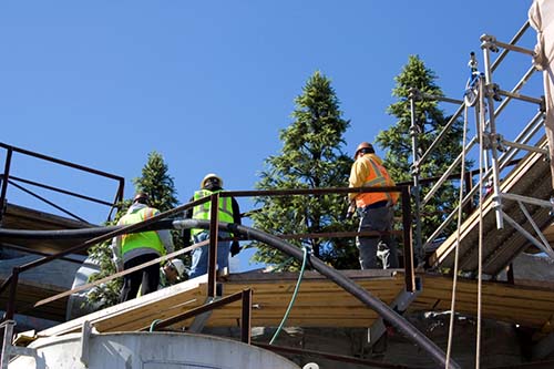 image of men working on a fabricated tree