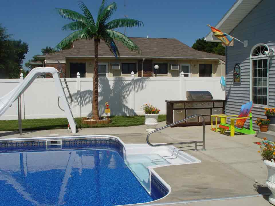 image of a fabricated palm tree beside a outdoor pool