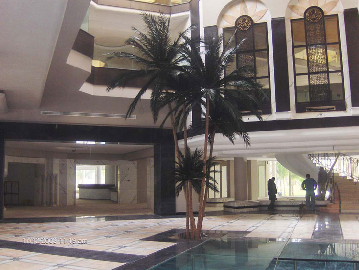 image of a artificial  palm tree by a pool